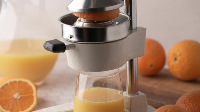 making fresh orange juice with squeezer