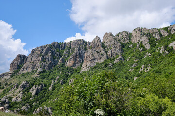 Fototapeta na wymiar A wall of stone cliffs over the Valley of Ghosts. Demerdzhi mountain range, Crimea.