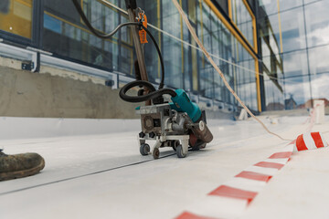 Worker welding pvc  membrane by heater with welder machine