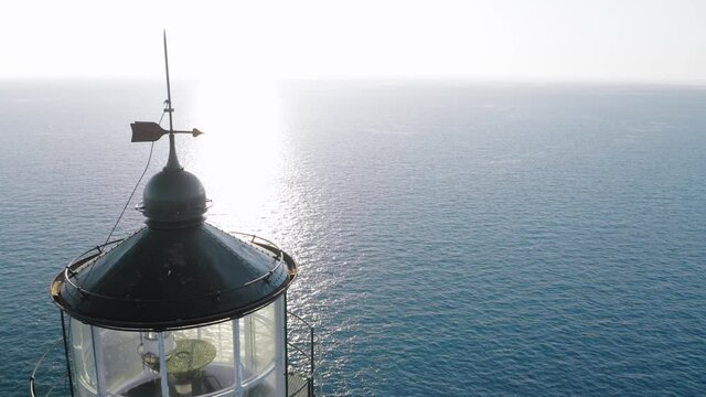 Drone close up view of top part of lighthouse during sunset, famous cape of Ducato at Lefkada island.