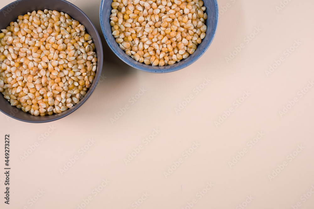 Sticker Top view of corn grains on bowls isolated on a light brown background