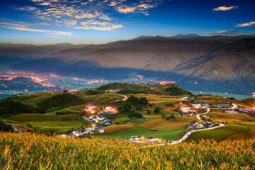 Autumn scenery of Lioushidan Mountain (Sixty Stone Mountain). Resplendent Sunshine on sea of golden-colored Daylily Blossoms by the Trails of village & Crepuscular ray is Taiwan aesthetic sense.