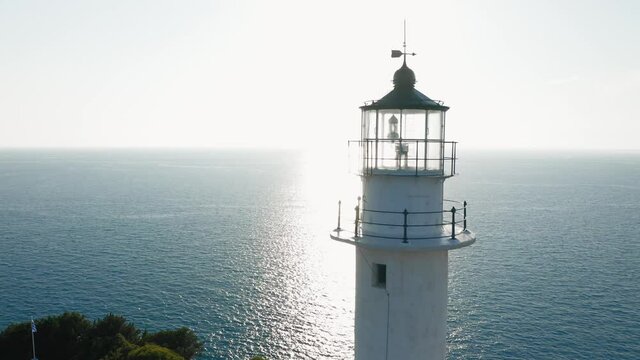 Close up aerial view of lighthouse top against sunlight, Cape of Ducato at Lefkada island.