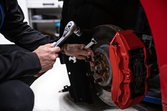 Man Car Mechanic Repairing Car Brakes In Car Service