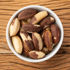 Brazil nuts in a bowl over wooden table
