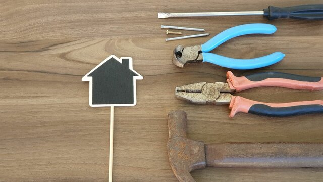 Labor day or worker's day. Work tools, blackboard, wooden background. Happy labor day concept, happy workers day. Space to write.