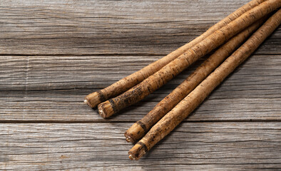 A burdock on a wooden board background
