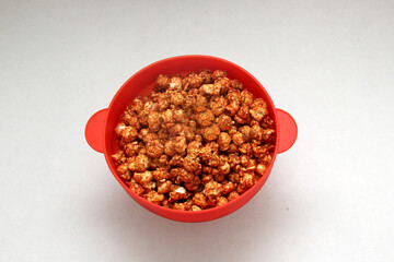 Chili Covered Popcorn Made in Red Microwave Container
