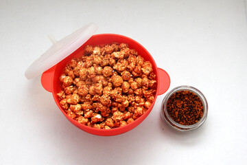 Chili Covered Popcorn Made in Red Microwave Container
