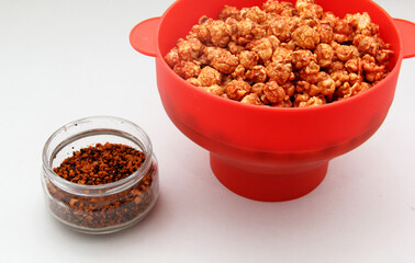 Chili Covered Popcorn Made in Red Microwave Container
