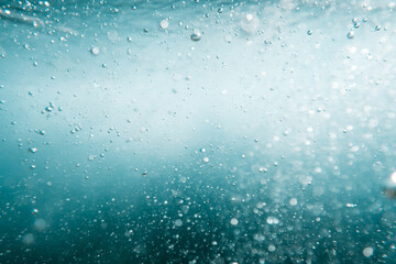 Underwater View of Bubbles In Deep Blue Ocean. Close Up Water. Background