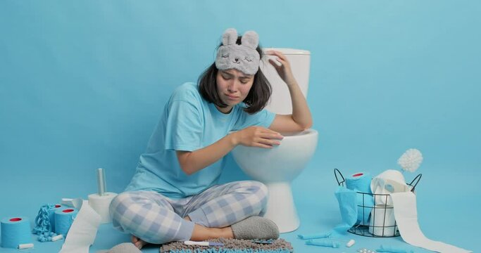 Upset Asian Woman Looks Frustrated Finds Out Pregnancy Result Feels Stressed Of Unwanted Results Or Infetility Wears Sleemask Pajama Leans On Toilet Bowl In Restroom Expects Baby. Unplanned Maternity