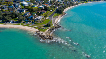 Aerial View of Grahams Beach close to the park, Green Trees and Cliff in New Zealand - Auckland Area