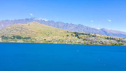 Fototapeta na wymiar Aerial View from Houses close to the Beach, Lake Wakatipu, Green Trees, Mountains - Queenstown in New Zealand