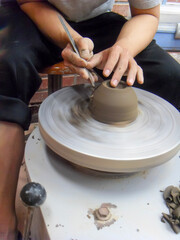 The hand of a man who makes pottery out of clay.