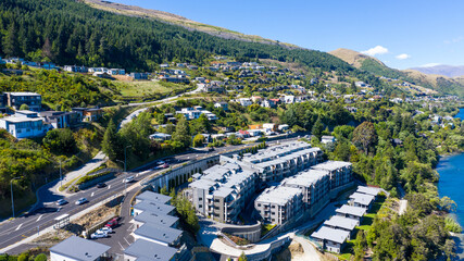 Aerial View from Houses close to the Beach, Lake Wakatipu, Green Trees, Mountains - Queenstown in New Zealand