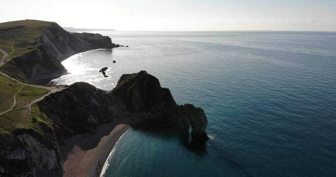 Aerial Over Silhouette Of Durdle Door Arch In Dorset During Morning Sunrise. Dolly Left silhouette
