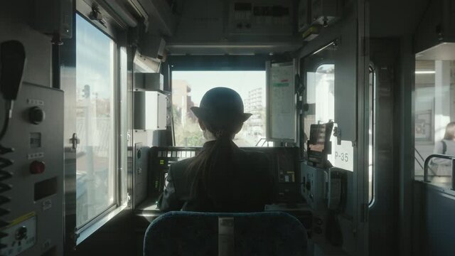 Back View Of A Female Conductor Preparing The Train Cab Before Departure At The Railway Station In Sendal, Japan. static shot