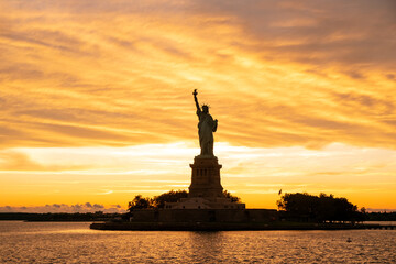 The Statue of Liberty at New York city during sunset © Kenishirotie
