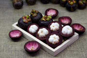 mangosteen fruit on wooden plate