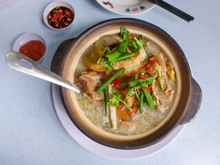 Popular Chinese cuisine. Fish Head Noodle Soup. Deep fried grouper fish head, thick rice noodle, creamy sourish broth with pickled mustard vegetable, tomatoes, sour plum and evaporated milk
