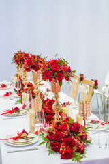 luxury wedding decor with flowers and glass vases and number of setting on tables