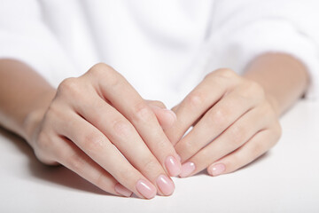 hands with pink gentle manicure. Spa care for hands and nails