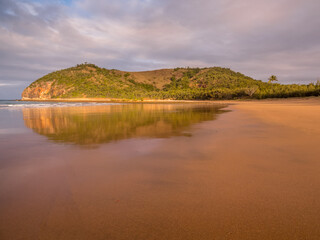 Seaside Afternoon with Golden Light on a Headland and Reflections