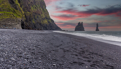 The black sand beach of Reynisfjara and the mount Reynisfjall from the Dyrholaey promontory in the...