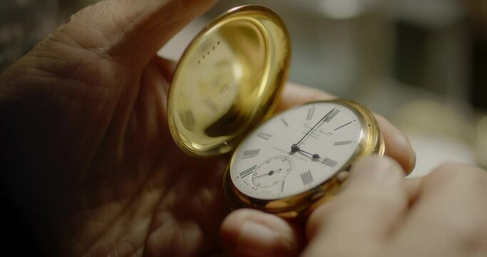 A person opens a pocket watch
