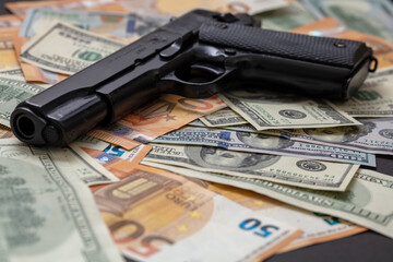 Criminal money. Pistol on dollar and euro banknotes background. Mafia and corruption concept, - obrazy, fototapety, plakaty
