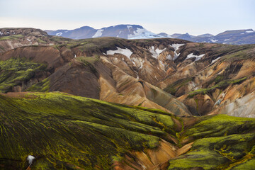 The rugged volcanic landscape of Landmannalaugar seen from the summit of Blahnúkur volcano,...