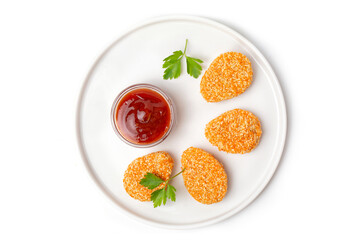 A pile of cooked chicken nuggets in a plate with tomato sauce, isolated on a white background