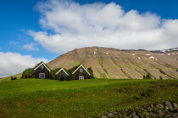 Fototapeta na wymiar Icelandic turf houses in blue sky