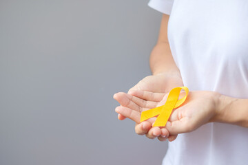 Obraz premium Suicide prevention day, Sarcoma, bone, bladder and Childhood cancer Awareness month, Yellow Ribbon for supporting people living and illness. children Healthcare and World cancer day concept