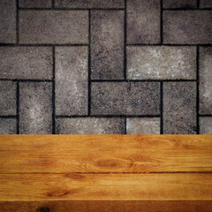The background is blank wooden boards and a textured brick wall with lighting and vignetting.