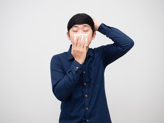 Sick man feeling sick and headache touch his head holding tissue paper at face on white background