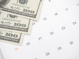 Closeup money on table of calendar