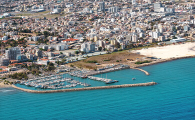 Sea port city of Larnaca, Cyprus. View from the aircraft to the coastline, beaches, seaport and the architecture of the city of Larnaca.