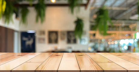 Empty wooden table top with lights bokeh on blur restaurant background