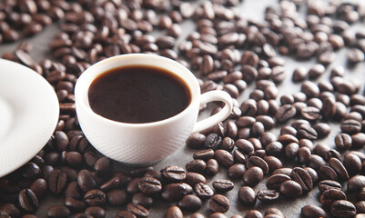 Cup of coffee on coffee beans.