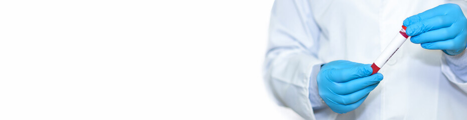 Fototapeta premium Doctor's hand holds test tube in blood.Banner. Copy space for text