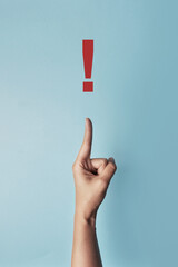 The person points to a red exclamation mark. Please pay attention