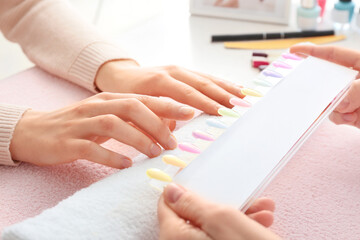 Obraz na płótnie Canvas Manicure master working with female client in beauty salon, closeup