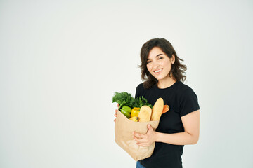 cute brunette package with groceries in a supermarket vegetable