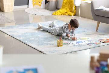Cute little boy painting at home