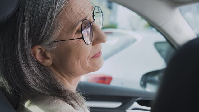 Mature tired woman sitting in car at parking lot, don&rsquo;t want to go to work