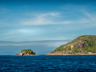 Fototapeta premium Rocky Island of the Coast on a Blue Sky Day