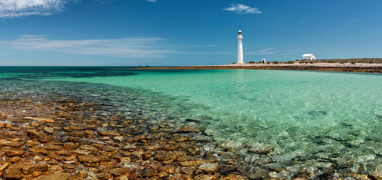 rocky bay with lighthouse and outbuildings