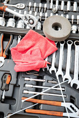 a man repairs a car. a man in blue special clothes to repair the car. engine parts machine repair...